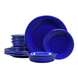 The Fiesta (FTC) Classic Rim 12-Piece Dinnerware Set in twilight features plates and bowls for 4, stylishly stacked against a white background—an elegant addition to any table.