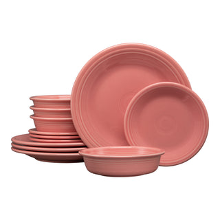 The Fiesta Classic Rim 12-Piece Dinnerware Set in peony, featuring plates, bowls, and side plates for four, is neatly stacked together on a white background.