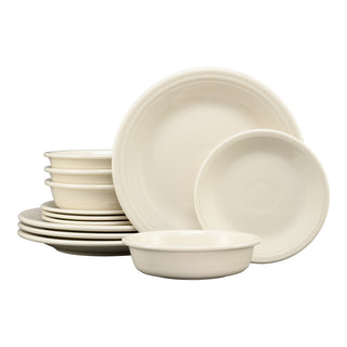The Fiesta Classic Rim 12-Piece Dinnerware Set in Linen features modern cream-colored plates and bowls, stacked and arranged in groups against a white background. Service for 4.