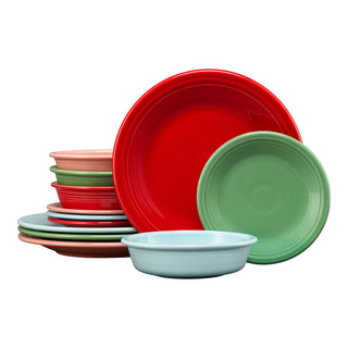 A stack of Fiesta's Peppermint Frost Mixed Color Classic Rim 12-Piece Dinnerware Set for 4 showcases red, green, light blue, and pink plates and bowls, all layered together against a white background.