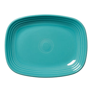 The Fiesta 12 Inch Large Rectangular Platter by Fiesta features a turquoise color, rounded corners, a concentric circle pattern at the center, and a glossy finish—ideal for modern, stylish serving presentations.