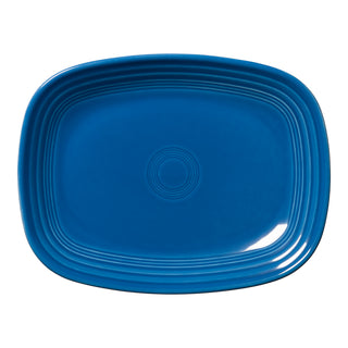 The Fiesta 12 Inch Large Rectangular Platter by Fiesta, shown in lapis blue, features rounded corners and concentric raised lines along the inner edge, and is photographed from above on a white background.