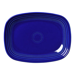 The Fiesta Retired 12 Inch Large Rectangular Platter in twilight features rounded corners and raised rings, making it a stylish serving tray. Crafted from deep blue ceramic and proudly made in the USA.