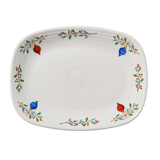 The Fiesta Retired Holly Berry Christmas Sprig 12" large rectangular platter features a white surface with red and blue leaves, green branches with red berries along the rim, and a plain center. This lead-safe china is made in the USA.
