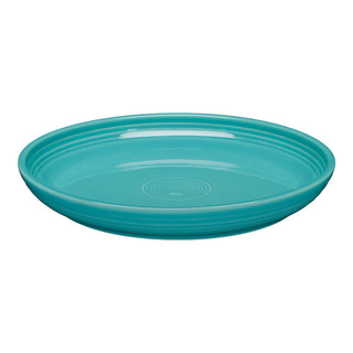 The Fiesta Coupe 10 3/8 Inch Dinner Bowl (40 OZ) in turquoise features a glossy finish with concentric circle patterns on the rim. Microwave safe, this ceramic bowl adds elegant style and function to your table setting. Shown against a white background.
