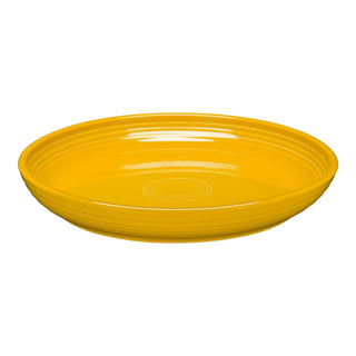 The Fiesta Coupe 10 3/8 Inch Dinner Bowl (40 oz) in daffodil features a bright yellow, round design with glossy concentric ridges on the rim. Set against a white background, this versatile bowl is microwave safe.
