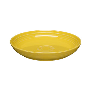 The Fiesta Coupe 8 1/2 Inch Luncheon Bowl (26 OZ) in sunflower is a round, shallow bowl with interior concentric circles, shown on a white background. This versatile piece combines style and function for any meal.