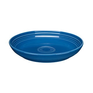 The Fiesta Coupe 8 1/2 Inch Luncheon Bowl (26 OZ) in lapis features a glossy finish and concentric circular ridges inside and at the center. Shown on a white background, it's perfect for multi-purpose use.