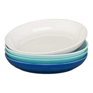 The Fiesta Mixed Coastal Blues Coupe 8 1/2 Inch Luncheon Bowl Set includes four 26 oz bowls in white, light blue, teal, and dark blue, each with a glossy finish and slightly raised rim—perfect for your Fiesta collection.