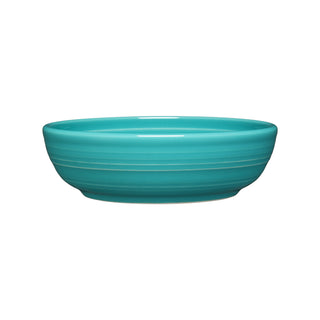 The Fiesta Coupe 6 3/4 Inch Salad Bowl, 24 OZ, features a glossy turquoise finish with subtle horizontal ridges. Dishwasher safe for easy cleaning, it's shown against a white background.