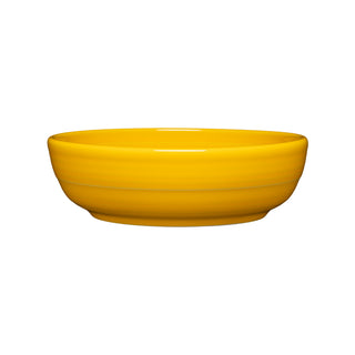 The Fiesta Coupe 6 3/4 Inch Salad Bowl in daffodil features a smooth, glossy finish. This 24 oz ceramic bowl is dishwasher safe and shown from the side against a plain white background, perfect for easy cleanup.