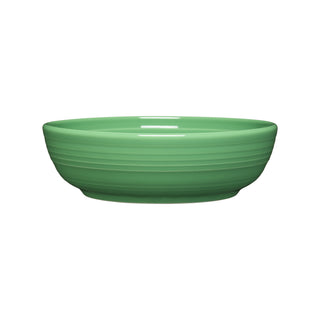 The Fiesta Coupe 6 3/4 Inch Salad Bowl, 24 OZ in meadow features a smooth, glossy ceramic finish with subtle horizontal ridges. Dishwasher safe for easy cleaning, it’s shown on a white background.