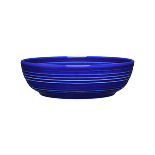 The Fiesta Coupe 6 3/4 Inch Salad Bowl (24 OZ) in twilight is a deep, round ceramic bowl with horizontal white stripes, shown on a white background. It's dishwasher safe for easy cleaning.