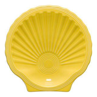 The Fiesta Retired Shell Shaped Plate (8 1/4 OZ) in sunflower features radiating ridges and a scalloped edge. This lead-safe china plate is made in the USA.