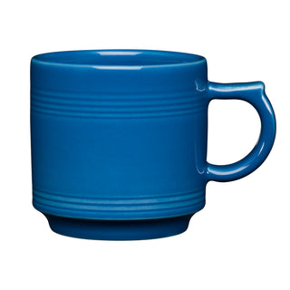 The Fiesta 16 OZ Stackable Mug by Fiesta, in lapis blue, features a large handle and subtle horizontal ridges—ideal for any coffee bar setup. Shown against a white background.