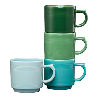 The Fiesta Aegean 16 OZ Set of 4 Mixed Stackable Mugs features green and blue shades stacked together, with an additional light blue mug displayed separately in front.