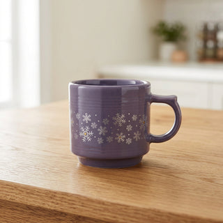 Light purple, 16oz stackable Fiesta Lavender Snowflakes mug featuring a pattern of white snowflakes around the center.