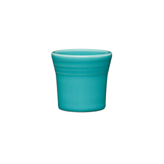 The Fiesta 1 1/2 OZ Ceramic Shot Glass by Fiesta, in turquoise, features a small cylindrical shape with a slightly flared rim and subtle horizontal ridges near the top. Made in the USA and shown against a white background.