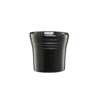 The Fiesta Foundry 1 1/2 OZ Ceramic Shot Glass features a matte black finish, slightly tapered shape, and subtle horizontal ridges near the rim. Crafted from durable vitrified china in the USA, it's shown against a plain white background.