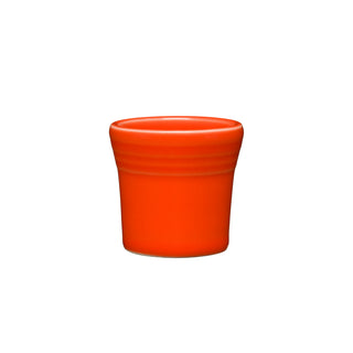 The Fiesta 1 1/2 OZ Ceramic Shot Glass by Fiesta, in bright Poppy color with subtle grooves and a flared rim, is made in the USA, dishwasher safe, and pictured on a plain white background.