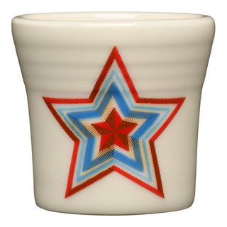 The Fiesta Americana Scarlet Faceted Star 1 1/2 OZ ceramic shot glass, made in the USA, features a large multi-colored star in red, blue, and brown on the front and is dishwasher safe for easy cleaning.