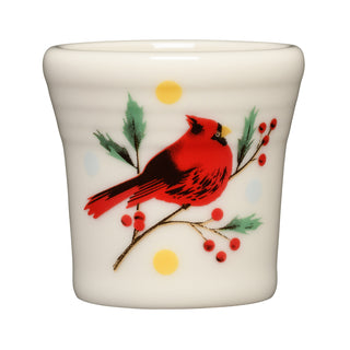 The Fiesta Jolly Christmas Cardinal 1 1/2 OZ Ceramic Shot Glass showcases a white ceramic design with a vibrant red cardinal perched on a branch, surrounded by green leaves, red berries, and cheerful yellow and blue dots in the background. Part of the Jolly Christmas Collection, this delightful shot glass brings festive charm to your holiday gatherings.