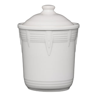 The Fiesta Retired 1 Quart Small Chevron Canister is a white ceramic jar with chevron-embossed edges and an airtight lid featuring a rounded knob handle—perfect for stylish kitchen storage.