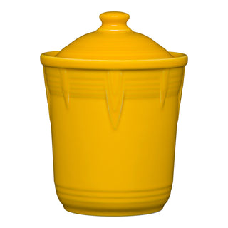 The Retired Fiesta 1 Quart Small Chevron Canister by Fiesta features a daffodil yellow color, airtight lid with rounded knob, vertical ridges on top, and a smooth, glossy finish—perfect for colorful kitchen storage.