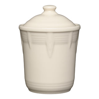 The Retired Fiesta 1 Quart Small Chevron Canister by Fiesta, in Linen color, features subtle chevron-embossed lines and a matching lid—perfect for airtight storage. Shown against a plain white background.