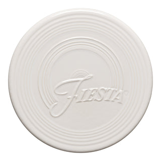 The Fiesta Extra Large Trivet 8 1/4 Inch in white features embossed concentric circles and raised "Fiesta" script, making it a stylish, heat-resistant addition to your kitchen.