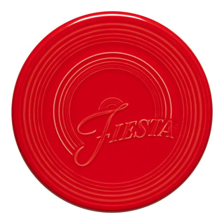 The Fiesta Extra Large Trivet (8 1/4 Inch) in vibrant Scarlet features embossed concentric rings and "Fiesta" scripted across the center.