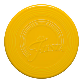 The Fiesta Retired Extra Large Trivet, 8 1/4 inch in daffodil, features a round ceramic design with concentric rings and "Fiesta" embossed at the center.