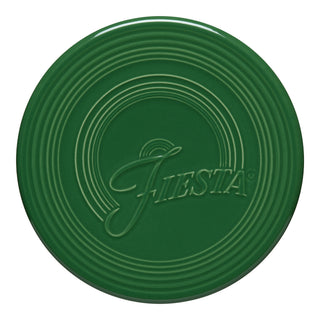 The Fiesta Extra Large Trivet, 8 1/4 Inch in Jade, features concentric circular ridges and “Fiesta” embossed at the center—stylish, durable, and heat resistant.