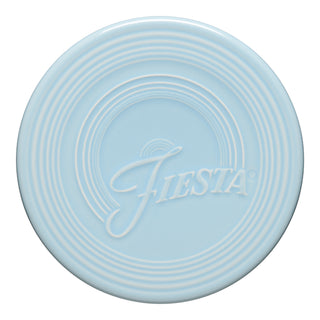The Fiesta Extra Large Trivet (8 1/4 Inch) in Sky features concentric ridges and "Fiesta" embossed in cursive—ideal for protecting surfaces.