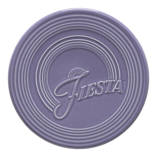 The Fiesta Lavender Extra Large Trivet (8 1/4 Inch) features a round design with raised concentric rings and the Fiesta name embossed at the center, providing stylish protection for your surfaces.