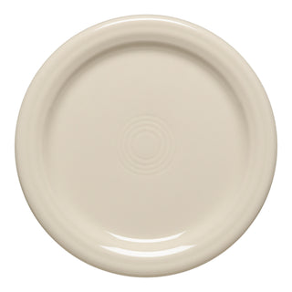 The Fiesta 4 3/8 Inch Coaster and Mug Cover by Fiesta features a round, linen-colored ceramic design with a glossy finish and concentric circles; it's microwave-safe for added convenience.