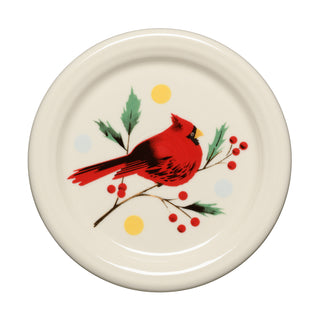 Brighten up your holiday table with the Fiesta Jolly Christmas Cardinal 4 3/8 Inch Coaster and Mug Cover, featuring a cream-colored background adorned with a vivid red cardinal resting on a branch of green leaves and red berries, accented by cheerful yellow and blue dots—an ideal addition to the Jolly Christmas Collection or a charming match for your favorite festive linen coaster.