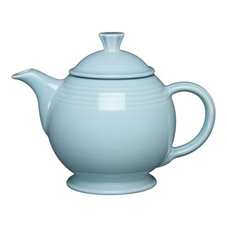 The Retired Fiesta 44 OZ Covered Teapot by Fiesta, shown in sky, has a round body, curved spout, large handle, and matching lid. Made from lead-safe china and displayed on a white background.