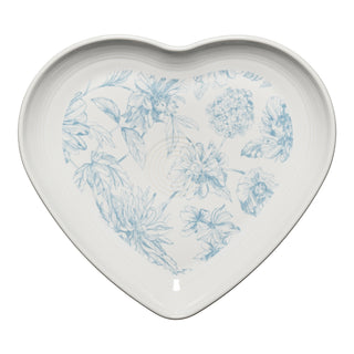 The retired Fiesta Botanical Floral 9-inch heart-shaped plate by Fiesta features a delicate light blue floral pattern with various flowers and leaves on a plain background.