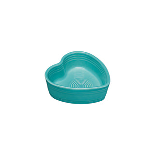 The Fiesta 7 OZ Heart Shaped Ramekin, 4 1/2 Inch in turquoise, features a smooth surface and concentric circles inside the bottom, displayed against a plain white background.