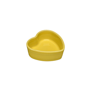 A sunflower yellow Retired Fiesta 7 OZ Heart Shaped Ramekin (4 1/2 inch), made in the USA by Fiesta, is photographed on a plain white background.