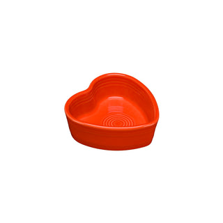 The Fiesta Retired 7 OZ Heart Shaped Ramekin in poppy is a 4.5-inch vitrified china dish with a smooth, glossy finish. Dishwasher safe and shown on a white background.