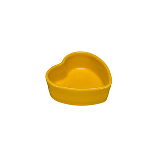 The Fiesta 7 OZ Heart Shaped Ramekin, 4 1/2 inch, in daffodil ceramic, is a small, yellow heart-shaped ramekin displayed on a white background.