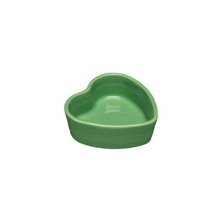 The Retired Fiesta 7 OZ Heart Shaped Ramekin, 4 1/2 Inch in meadow by Fiesta, made in the USA, is a green ceramic bowl displayed on a white background.