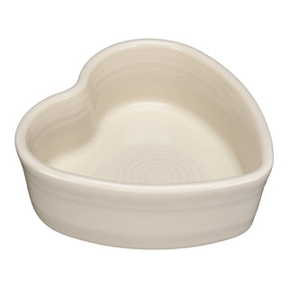 The Fiesta 7 OZ Heart Shaped Ramekin 4 1/2 Inch in linen features smooth, rounded edges and a glossy finish. This ceramic dish is displayed on a plain white background.