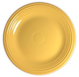 A round, yellow ceramic plate with a glossy finish and subtle concentric ring patterns near the rim, viewed from above on a white background.
