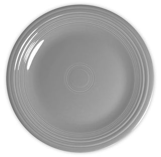 A plain, round, light gray ceramic plate with a glossy finish and concentric ridges along the edge, viewed from above against a white background.