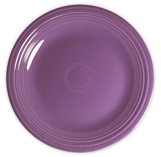 A round, purple ceramic plate with a glossy finish and concentric raised rings along the outer edge, viewed from above against a white background.