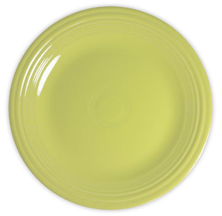 A round, light yellow plate with a glossy finish and concentric circular grooves near the rim, shown from above on a white background.