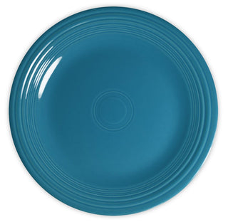 A round, turquoise-blue ceramic plate with concentric raised rings near the rim, viewed from above on a white background.